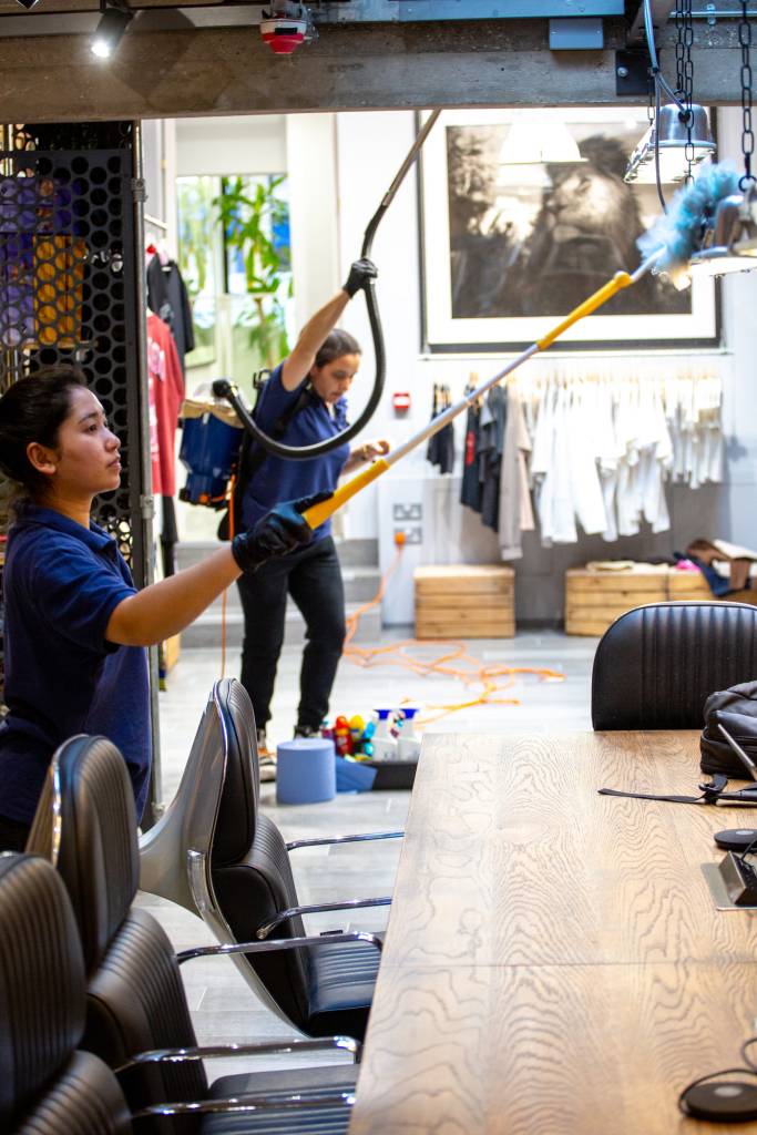Akacleaning team delivering high-detail cleaning in a corporate London conference room using professional tools and techniques.