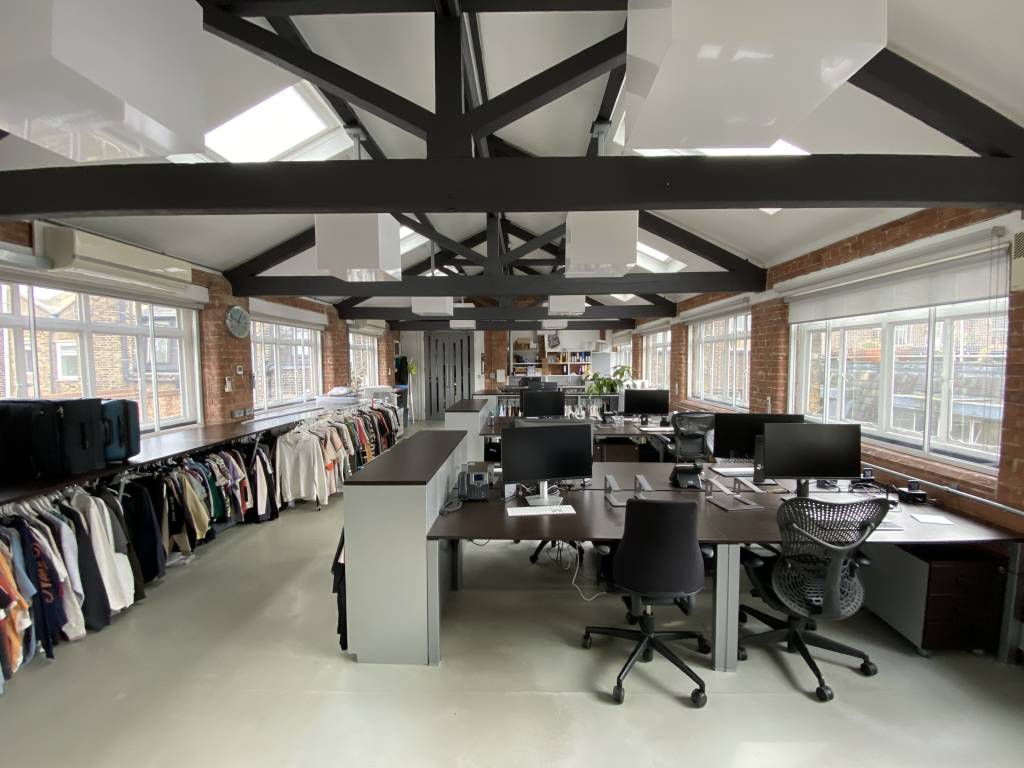 Open-plan office workspace with desks and meeting areas
