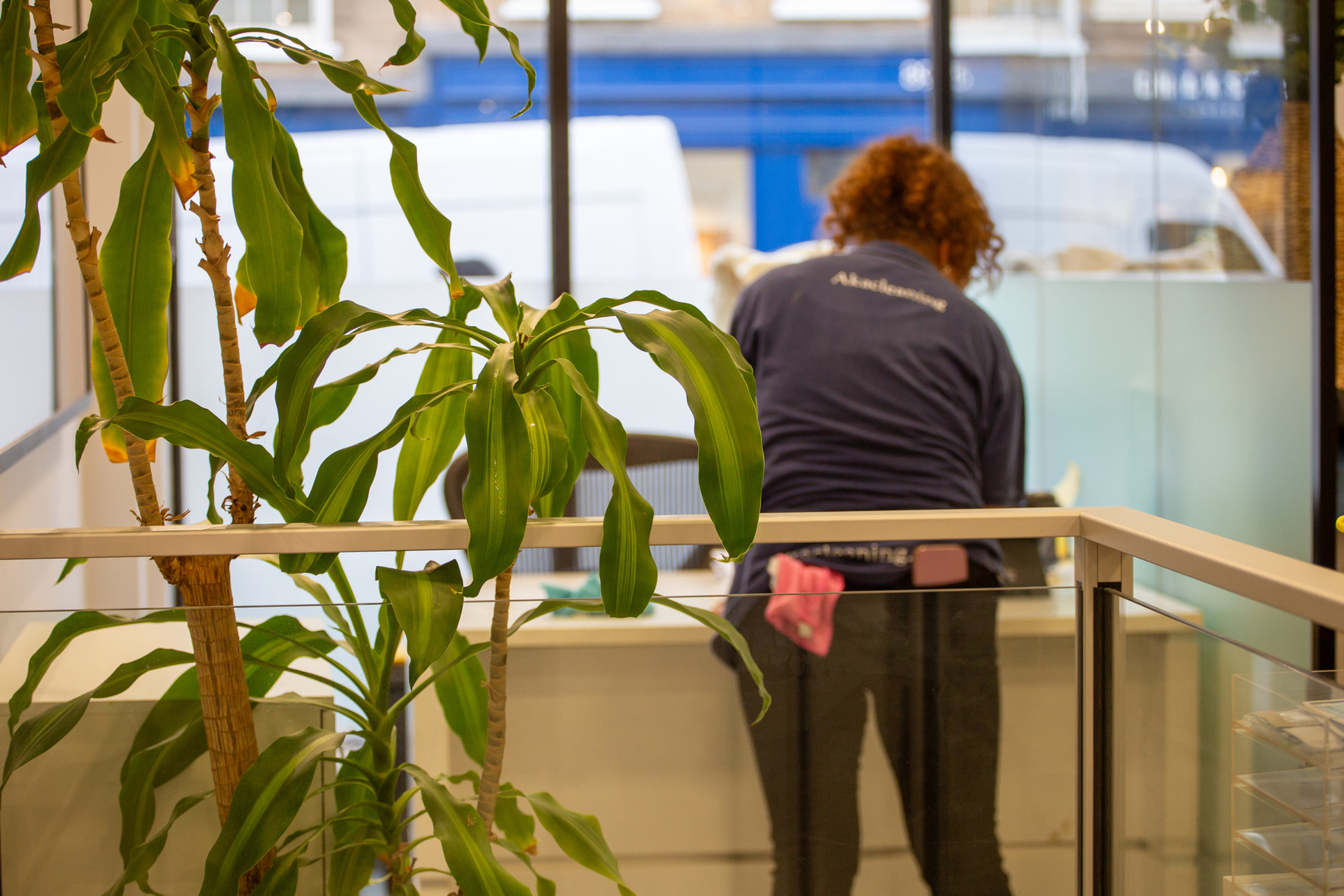 Commercial cleaning services, Akacleaning staff member performing office cleaning in London workspace. Professional cleaners.