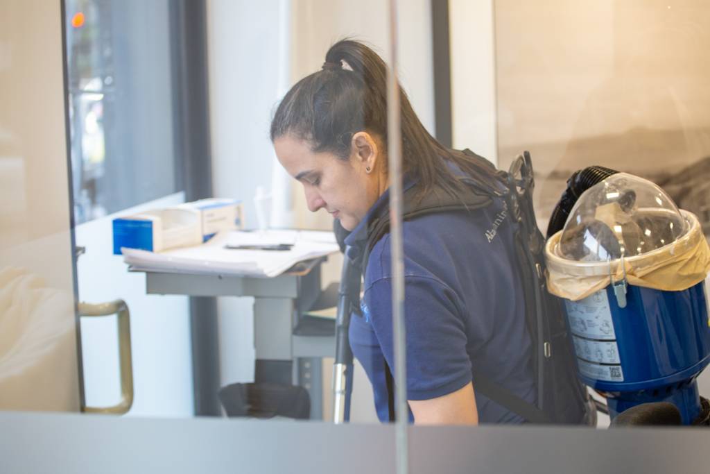 Akacleaning Ltd operative carrying out cleaning tasks in a London workspace